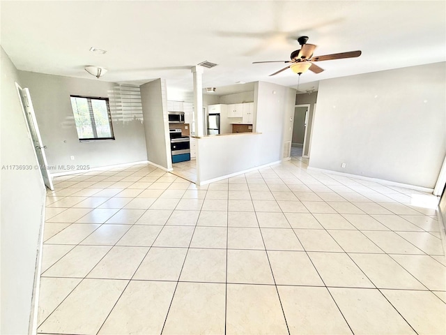 unfurnished living room with light tile patterned floors, ceiling fan, decorative columns, and visible vents