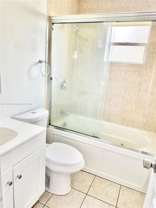 full bathroom featuring enclosed tub / shower combo, vanity, toilet, and tile patterned flooring