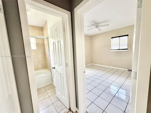 interior space featuring bathtub / shower combination, ceiling fan, baseboards, and tile patterned floors