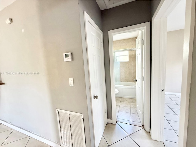 hall with light tile patterned floors and visible vents