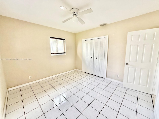 unfurnished bedroom featuring a closet, visible vents, ceiling fan, and baseboards