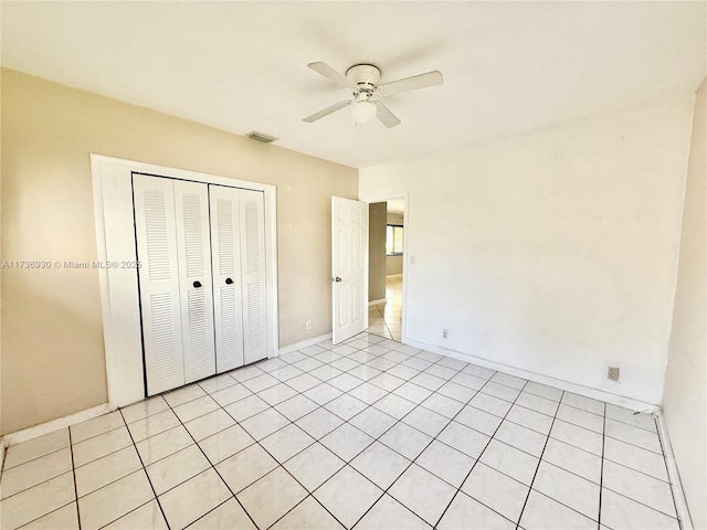 unfurnished bedroom featuring baseboards, a closet, visible vents, and a ceiling fan