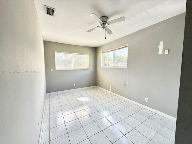 unfurnished room featuring light tile patterned floors and ceiling fan