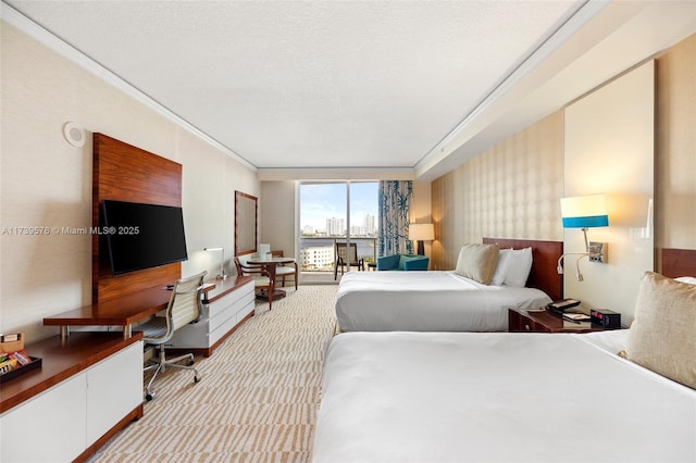 carpeted bedroom featuring ornamental molding and a textured ceiling