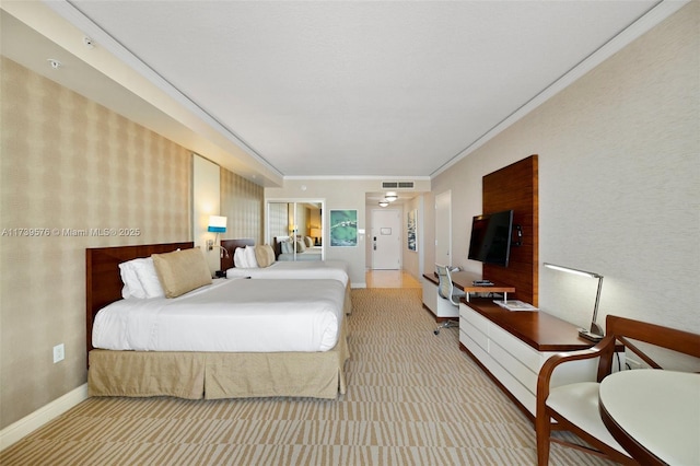 bedroom with crown molding and light colored carpet