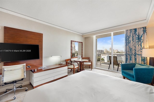 bedroom with crown molding, wood-type flooring, and access to outside