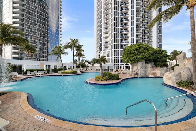 view of swimming pool with pool water feature