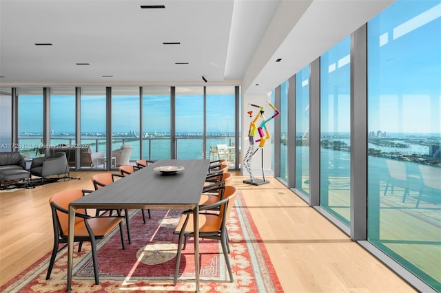 dining room featuring expansive windows and a water view