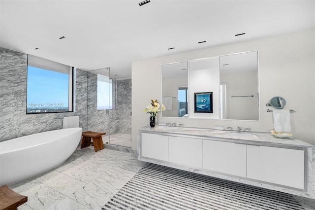 bathroom featuring vanity and shower with separate bathtub