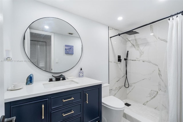 bathroom featuring vanity, toilet, and curtained shower