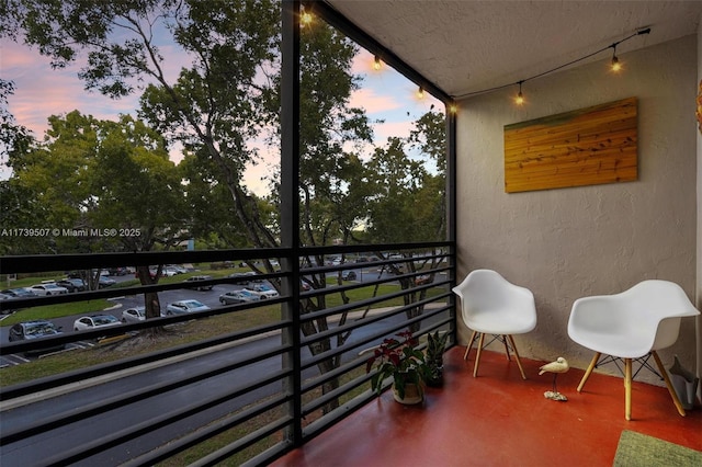 view of balcony at dusk