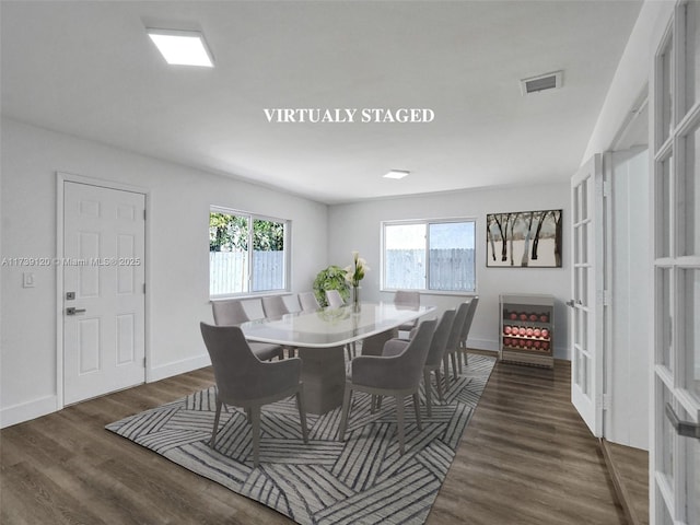 dining area with dark hardwood / wood-style floors