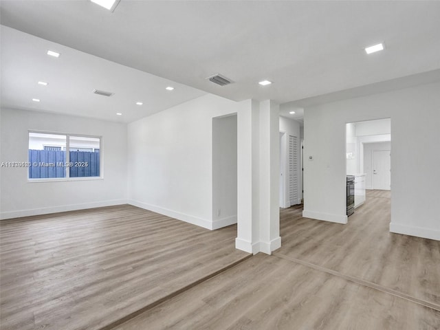 spare room featuring light wood-type flooring