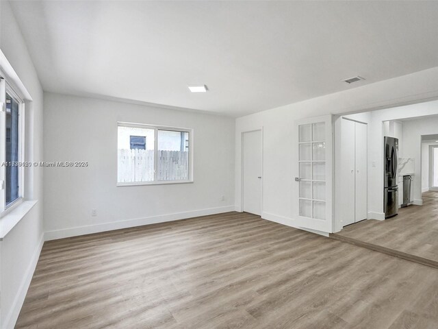 spare room with light hardwood / wood-style floors