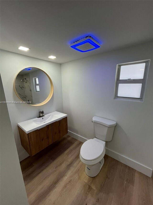 bathroom featuring hardwood / wood-style flooring, vanity, and toilet