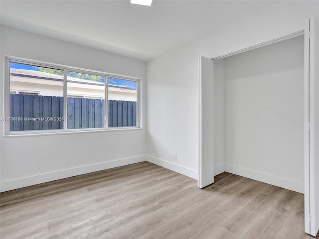 unfurnished bedroom featuring light wood-type flooring