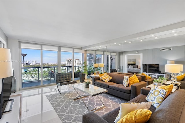 tiled living room featuring a wall of windows