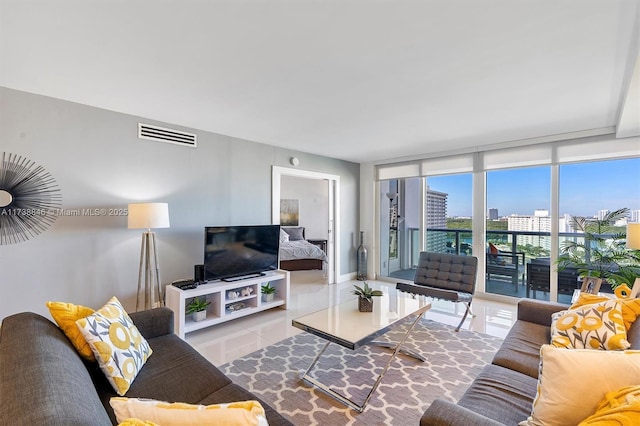 living room featuring light tile patterned flooring and floor to ceiling windows