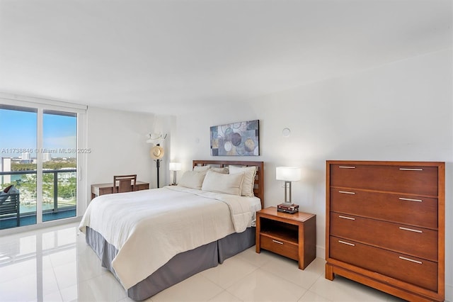 tiled bedroom with a wall of windows and access to exterior