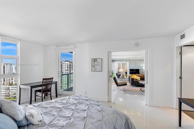 tiled bedroom featuring multiple windows and access to exterior