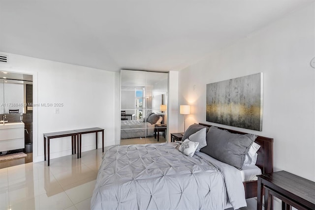 bedroom with sink and light tile patterned floors