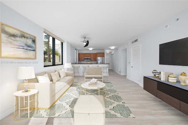 living room with light hardwood / wood-style flooring