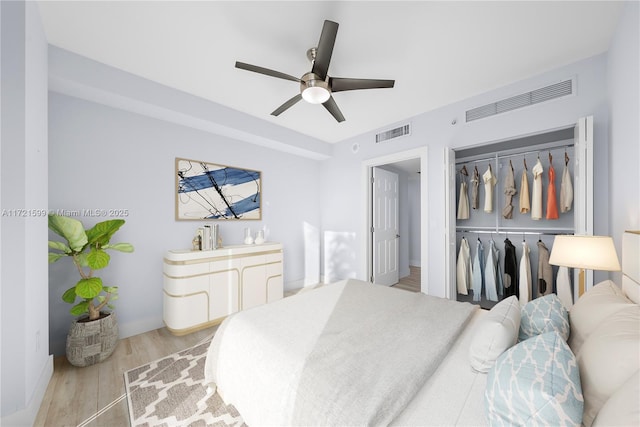 bedroom with ceiling fan, light hardwood / wood-style floors, and a closet