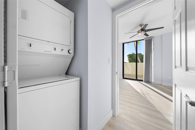 washroom with ceiling fan, stacked washer / dryer, and light hardwood / wood-style flooring