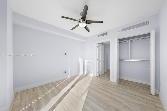 unfurnished bedroom featuring a closet, ceiling fan, and light wood-type flooring