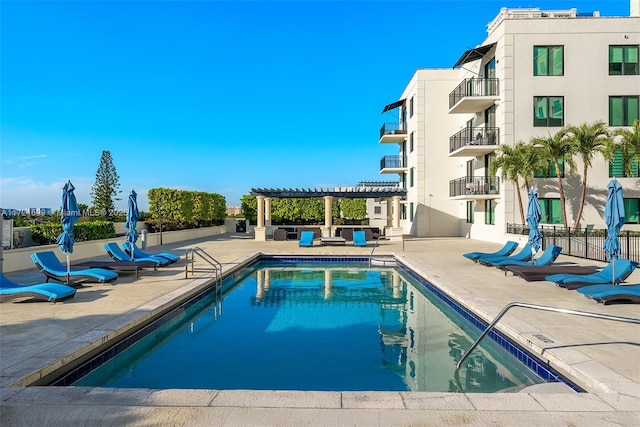 view of swimming pool with a pergola and a patio