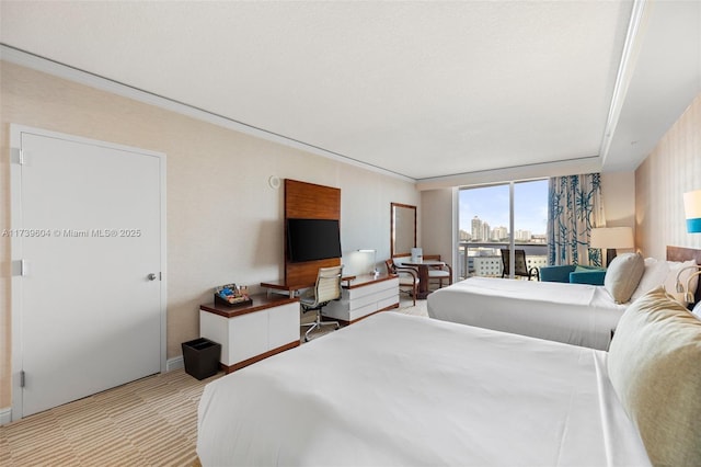 bedroom featuring ornamental molding, light colored carpet, and access to outside