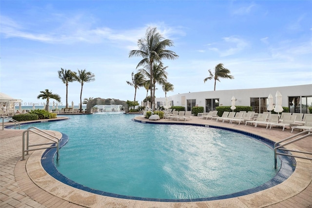 view of pool featuring pool water feature and a patio