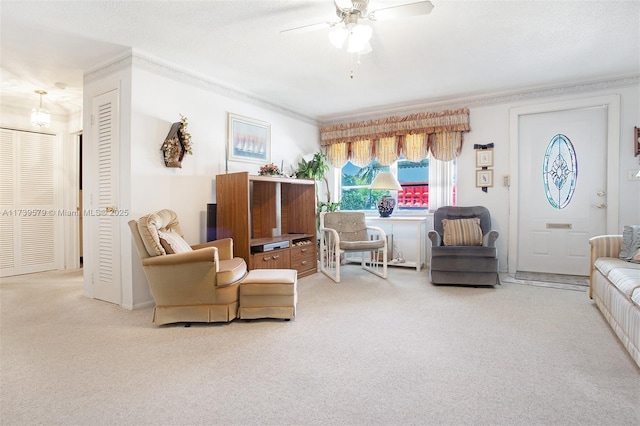 living room featuring crown molding, light colored carpet, and ceiling fan