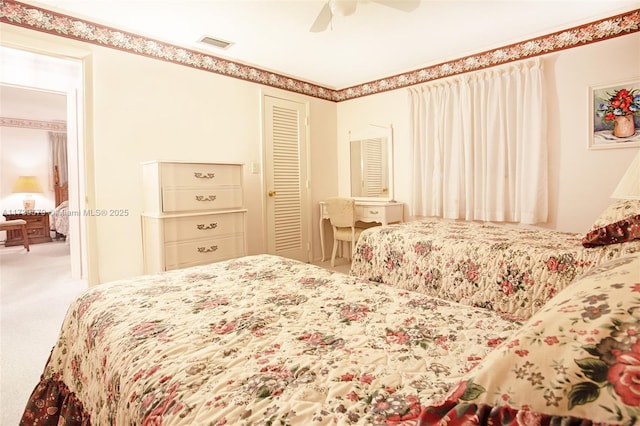 carpeted bedroom featuring a closet and ceiling fan