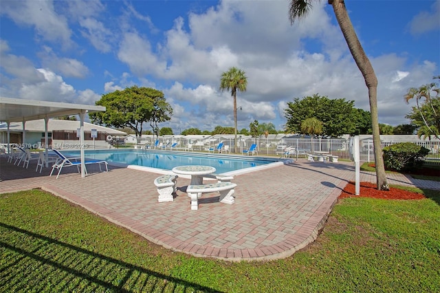 view of pool featuring a yard and a patio area