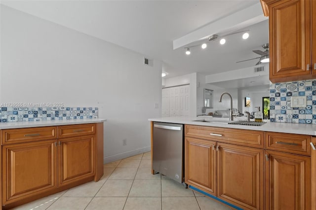 kitchen featuring light tile patterned flooring, sink, dishwasher, ceiling fan, and decorative backsplash