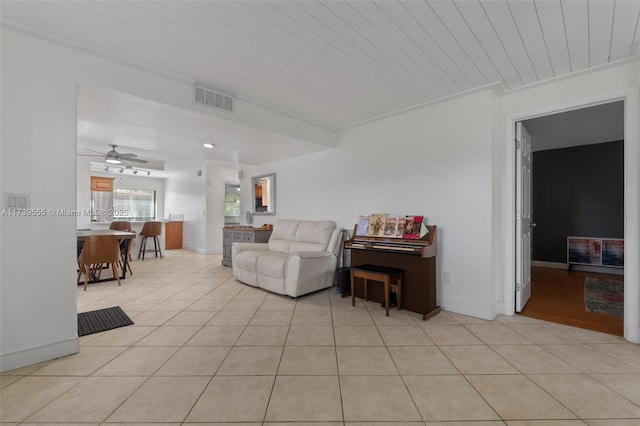 living room with light tile patterned floors and ceiling fan