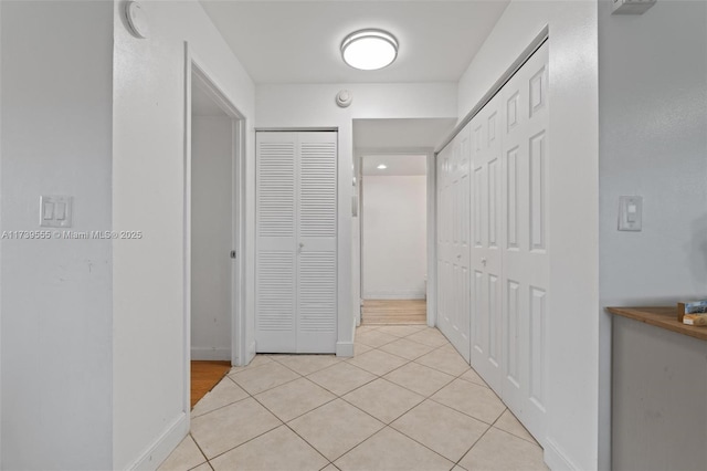 hall featuring light tile patterned flooring