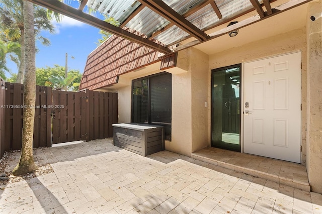 entrance to property featuring a patio area