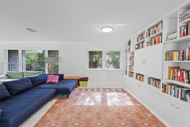 living room featuring plenty of natural light and built in features