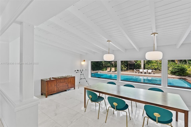 dining space featuring vaulted ceiling with beams