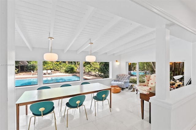 sunroom featuring lofted ceiling with beams