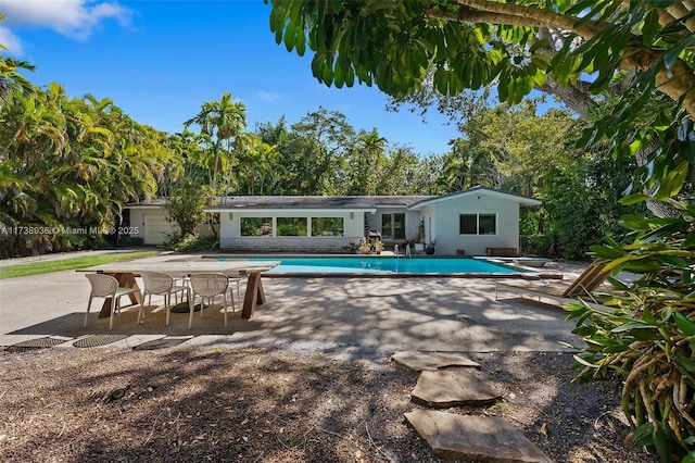 view of pool featuring a patio and a diving board