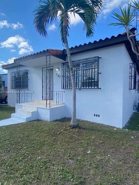 view of front of property with a front lawn and stucco siding