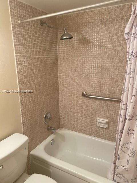 bathroom with shower / tub combo with curtain and toilet