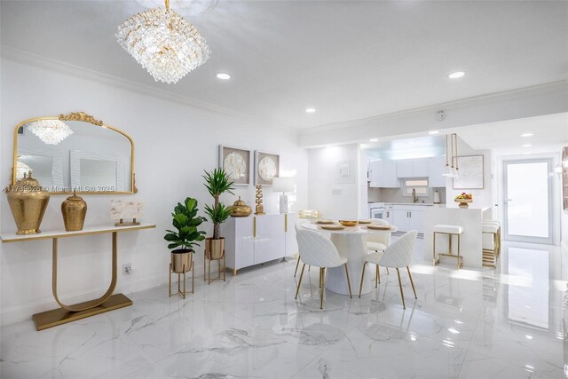 dining space with ornamental molding, sink, and a notable chandelier