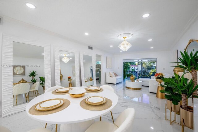 dining area with ornamental molding and a chandelier