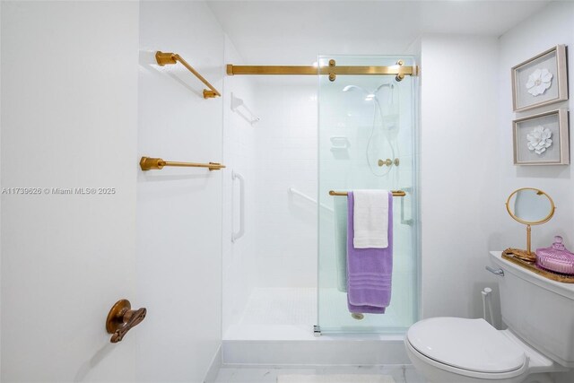 bathroom with toilet and an enclosed shower