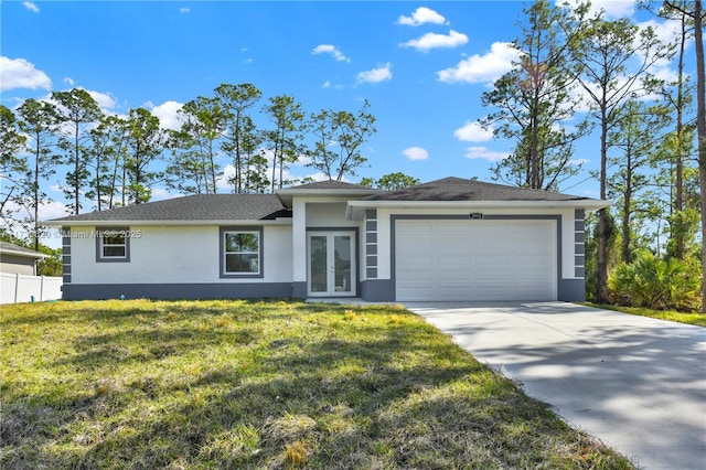 view of front of house with french doors, a garage, and a front lawn