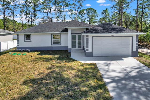 single story home with a garage and a front lawn